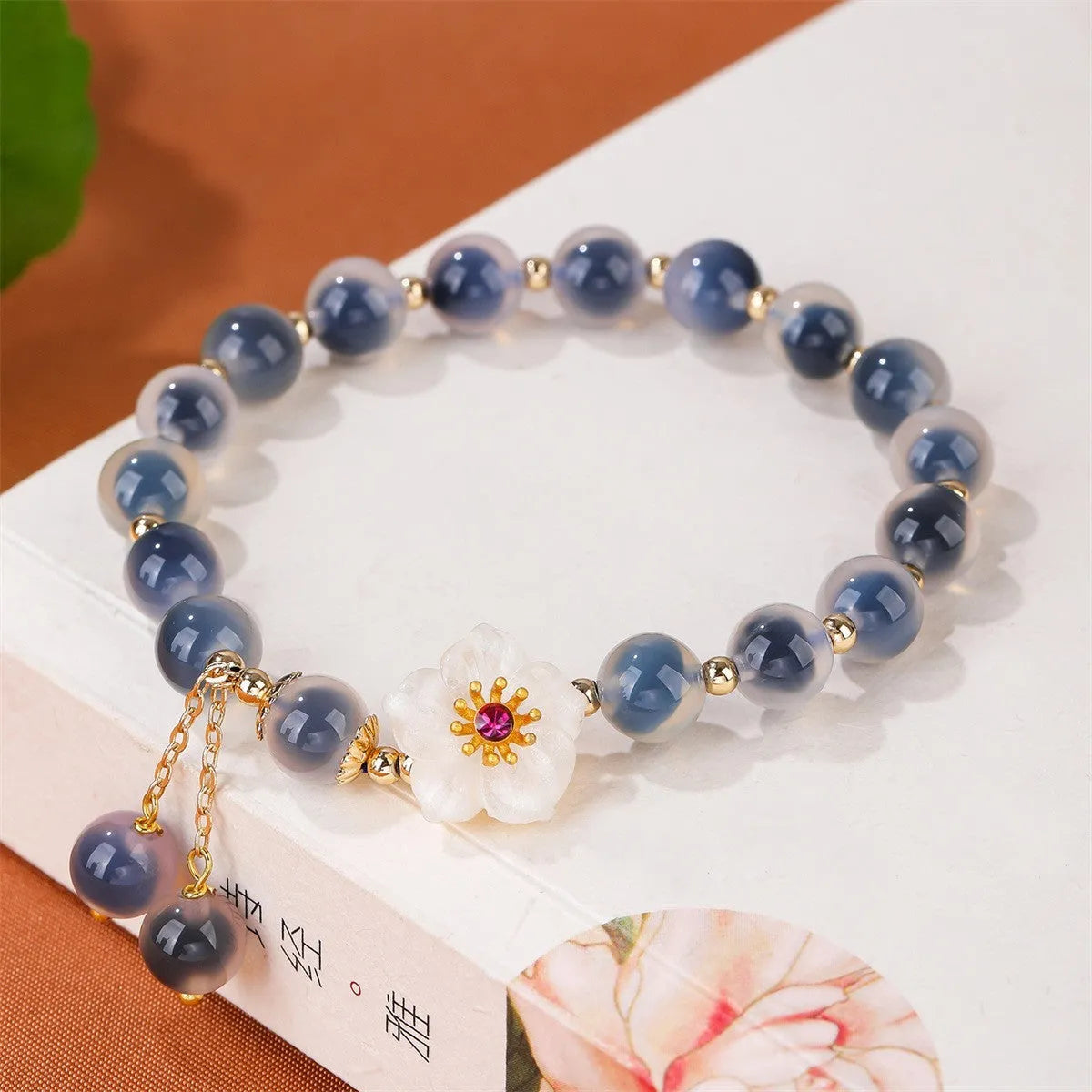 Handmade sugar heart agate bracelet with retro ethnic design on a wrist.