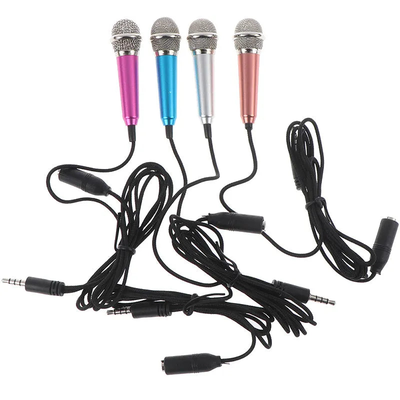 Portable 3.5mm mini karaoke microphone in rose gold with sponge head and stand on a table
