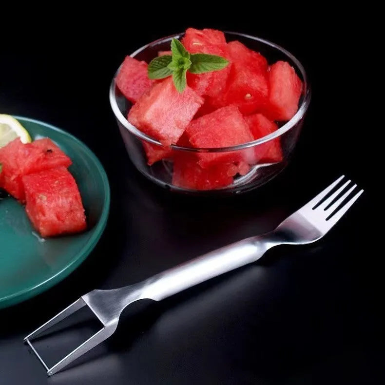 Stainless steel watermelon slicer and fork tool on a kitchen counter
