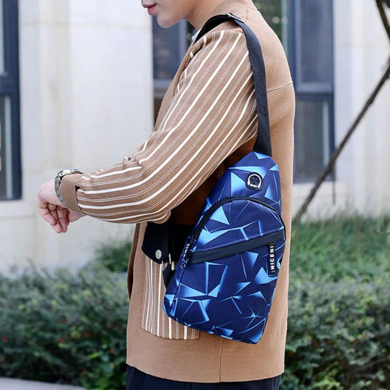 Blue Oxford cloth crossbody messenger bag with a strap, showing a front earphone hole and zipper closure.