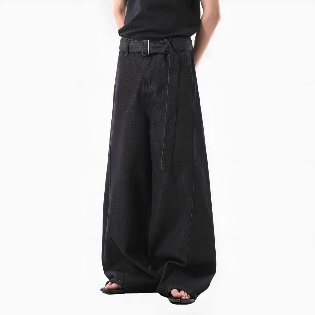 Black high-waist straight-leg jeans with gold contrast stitching on a flat lay.