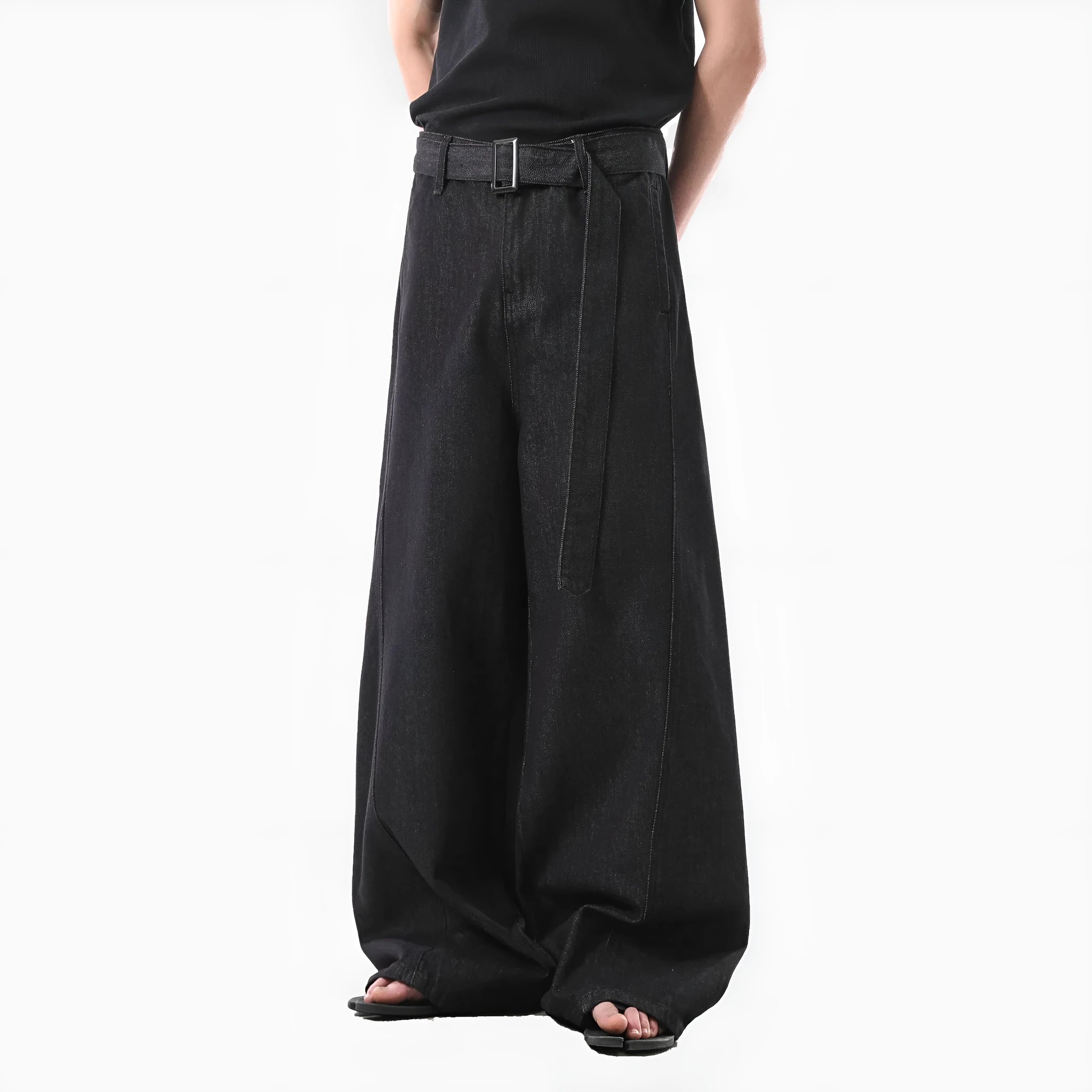 Black high-waist straight-leg jeans with gold contrast stitching on a flat lay.