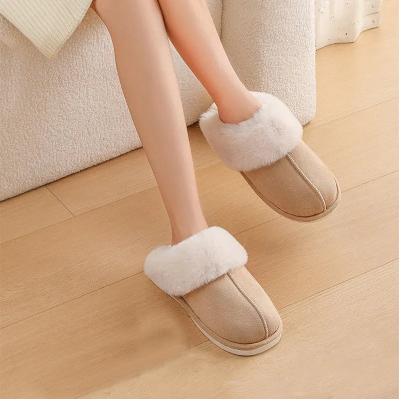 Women's brown plush indoor slippers with a round toe, flat heel, and stitching detail.
