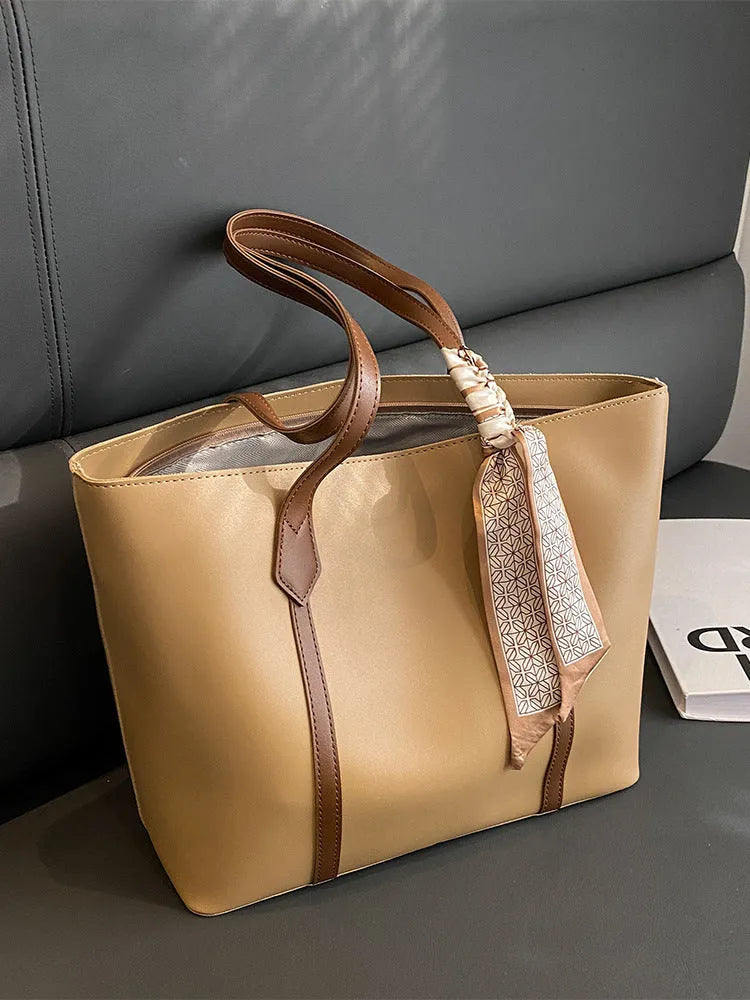 Large soft crossbody tote bag in bucket design showing colour options and internal zipped pocket