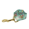 Four-piece dog accessory set with rose print bow, green fabric collar, leash and vest
