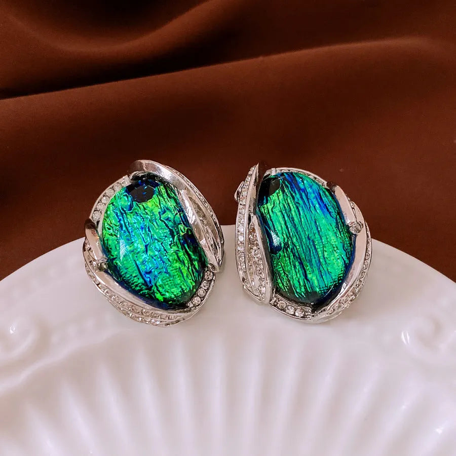 Silver resin stud earrings with rhinestone encrusting and irregular retro shape in silver needle green