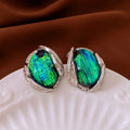 Silver resin stud earrings with rhinestone encrusting and irregular retro shape in silver needle green