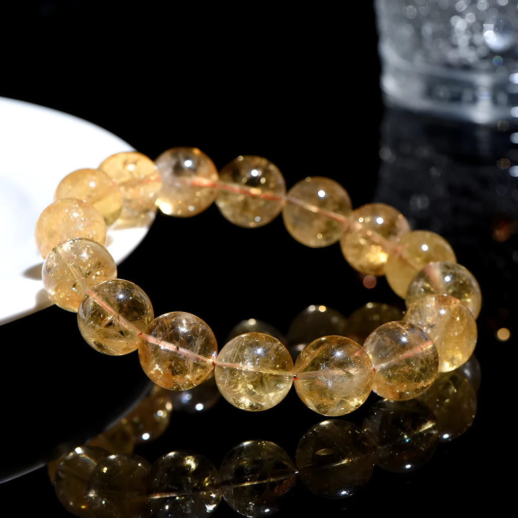 Natural yellow citrine bracelet with geometry-shaped beads in various sizes on a wrist.