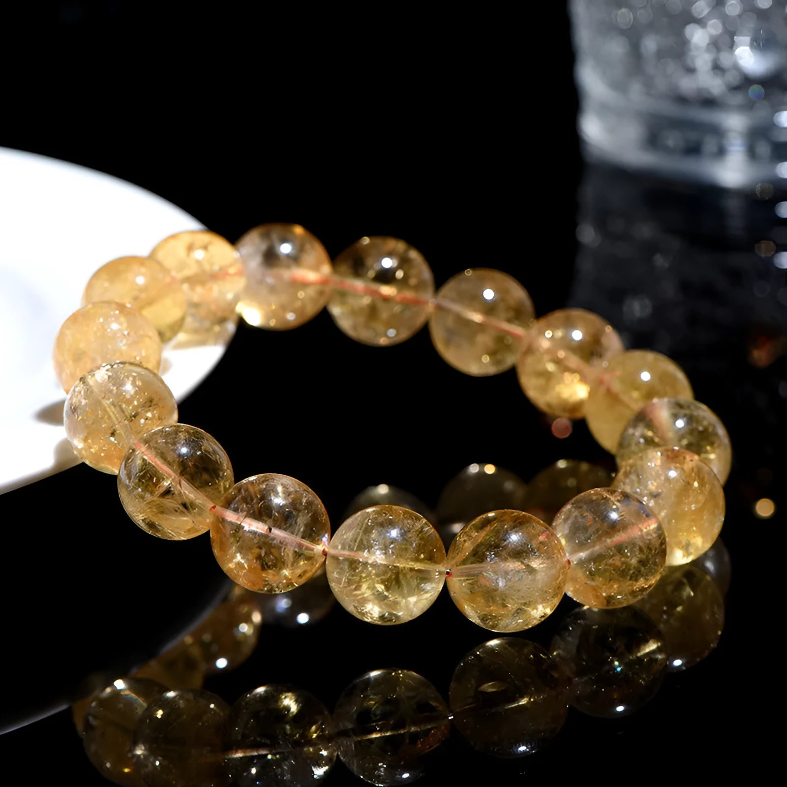 Natural yellow citrine bracelet with geometry-shaped beads in various sizes on a wrist.