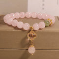 Pink crystal women's bracelet with four-leaf clover pendant and rhinestone details