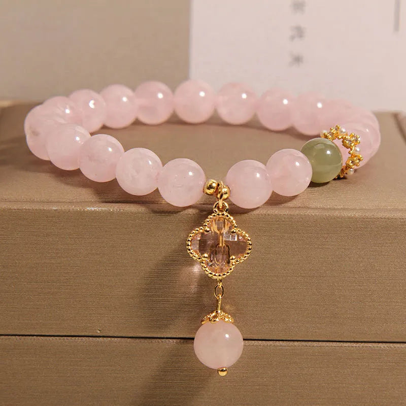 Pink crystal women's bracelet with four-leaf clover pendant and rhinestone details