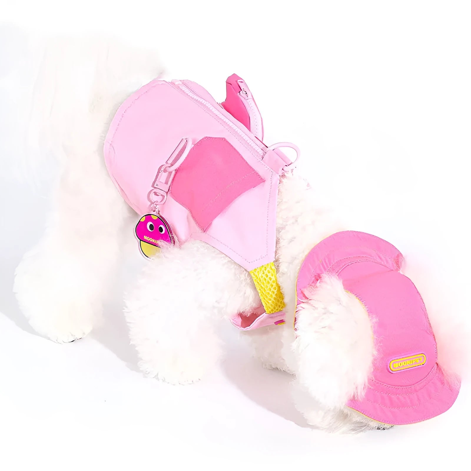 Pink polyester traction vest for small dogs on a Bichon Frisé, showing casual style and lead attachment point.