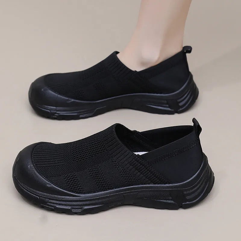 Women's black slip-on shoes with round toe design and soft PVC sole for casual wear