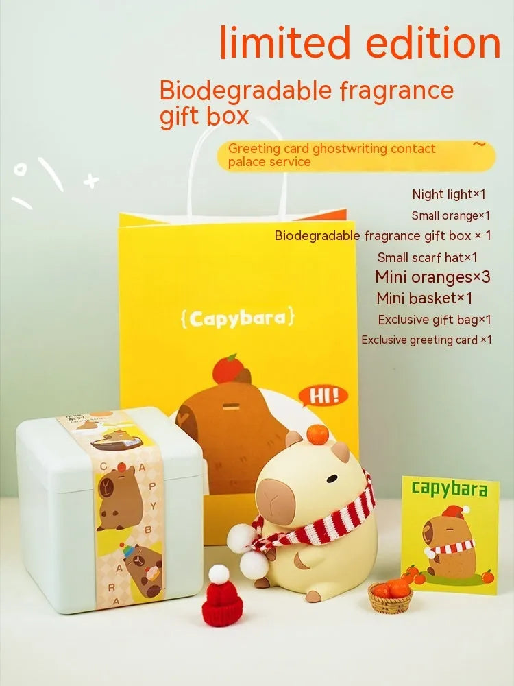 Small capybara-shaped night lamp in silicone and plastic, shown with USB cable.