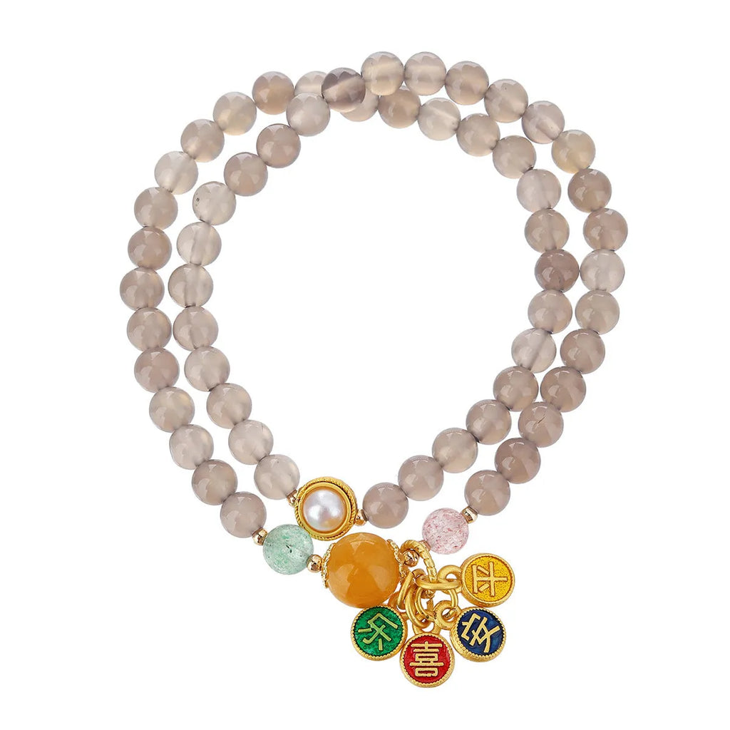 Close-up of a grey agate two-circle women's bracelet with a stainless steel clasp on a wrist.