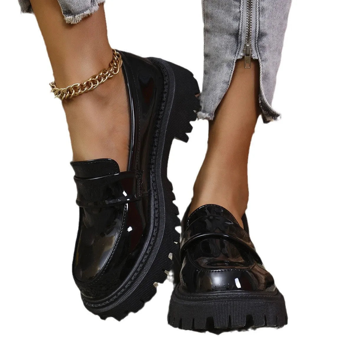 A pair of black plus size slip-on loafers with a chunky mid-heel and thick rubber sole on a plain background.