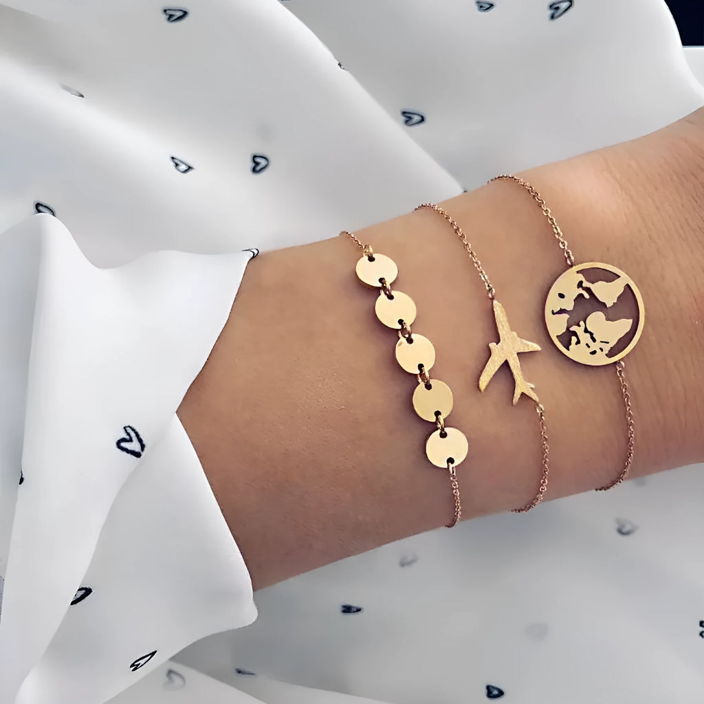 Three silver Bohemian bracelets with heart-shaped charms showing aircraft map details