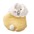Small dog wearing a lavender bunny embroidered pet coat with white ruffled collar and fluffy pom-pom tail