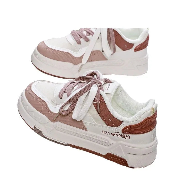 Beige children's platform trainers with cross shoulder straps and white laces on a 3cm thick rubber sole.
