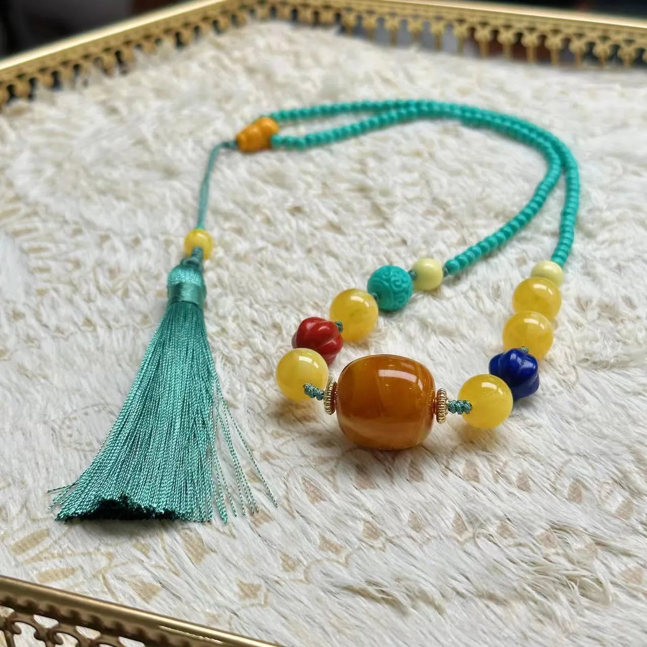 Turquoise mesh flower lucky pendant on a ball bead chain necklace, showing clasp.