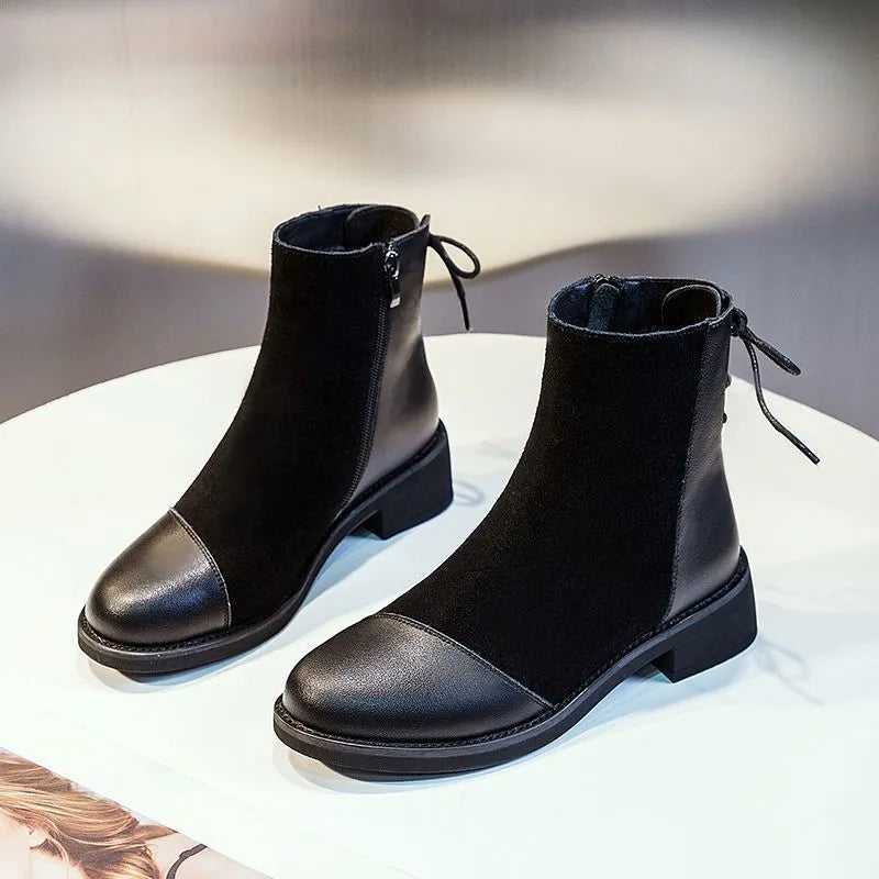 Black women's knee-high Martin boots with side zip and a decorative bow.