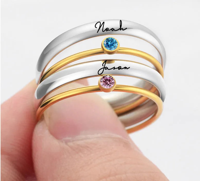 A geometric titanium steel ring with a December colour birthstone in an engraved, superimposed design.