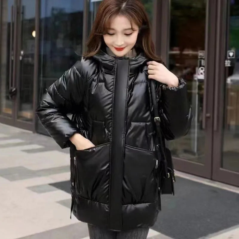 A woman's loose-fit hooded winter jacket in a poly-cotton blend, shown in a choice of colours including black and champagne.