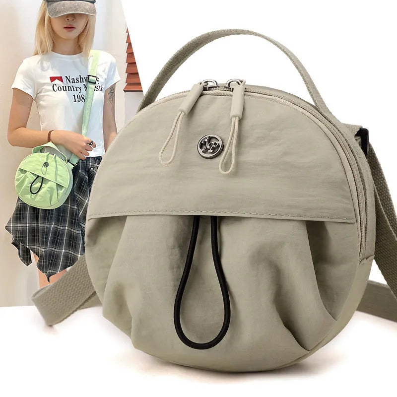 Nylon messenger crossbody bag with out shoulder design showing internal phone and document compartments