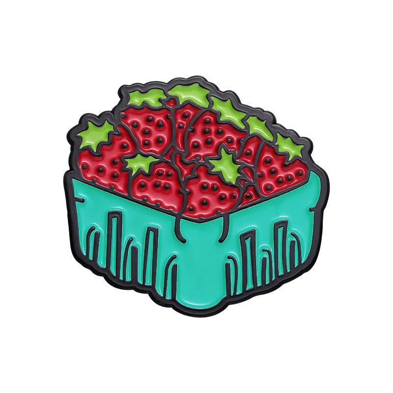 Colourful cartoon-style fruit metal brooch with pin back on a denim jacket lapel.