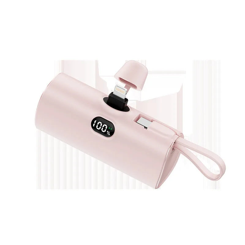 Colourful capsule-shaped power bank with digital display and a folding plug extended.