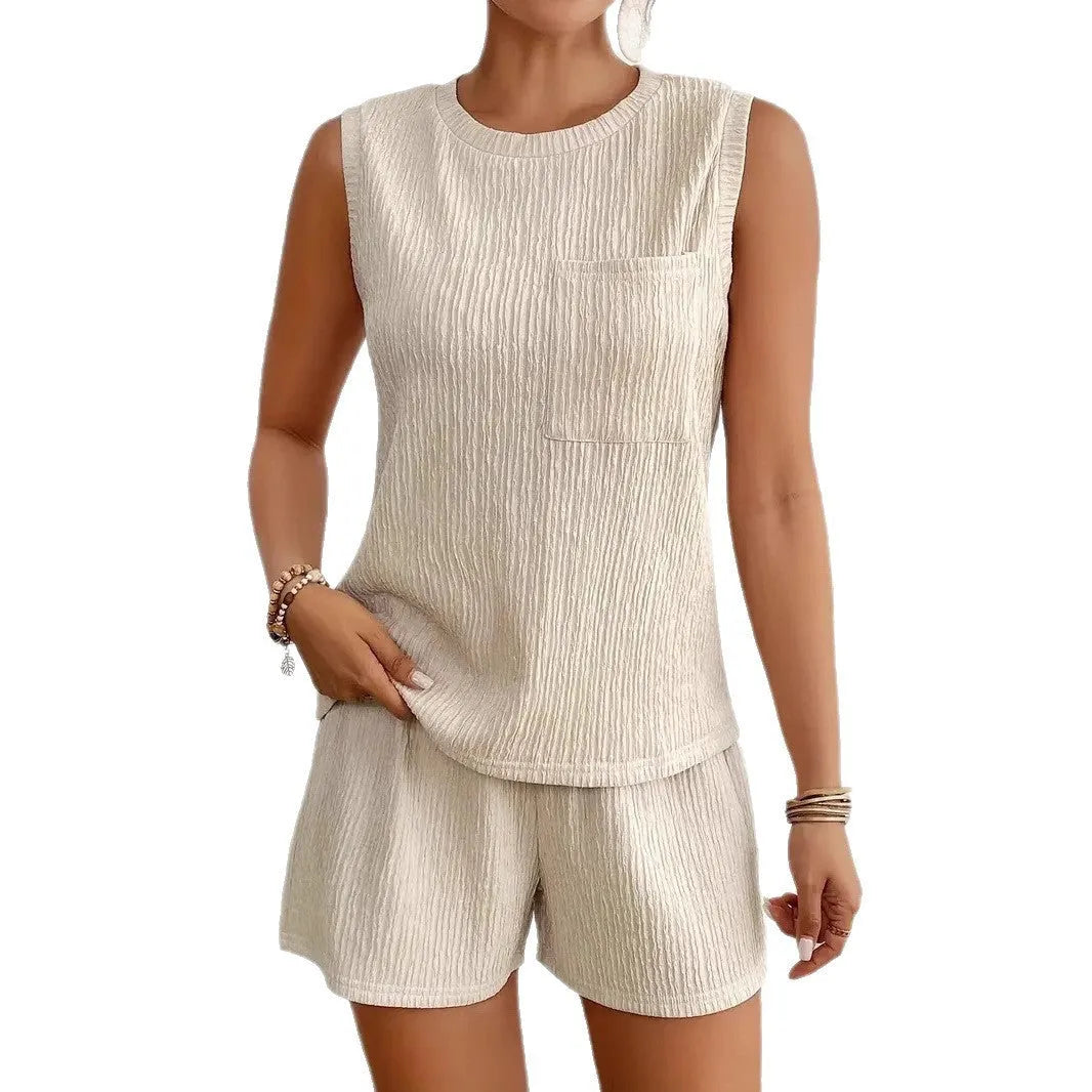 Apricot coloured sleeveless round neck vest and matching shorts set laid flat.