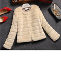 Women's short faux fur top in beige, black, or white, featuring regular sleeves.