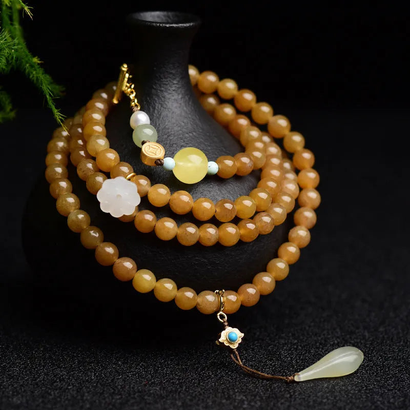 Women's green pine jade and beeswax bracelet with sequin leaves on a 6mm round bead strand.