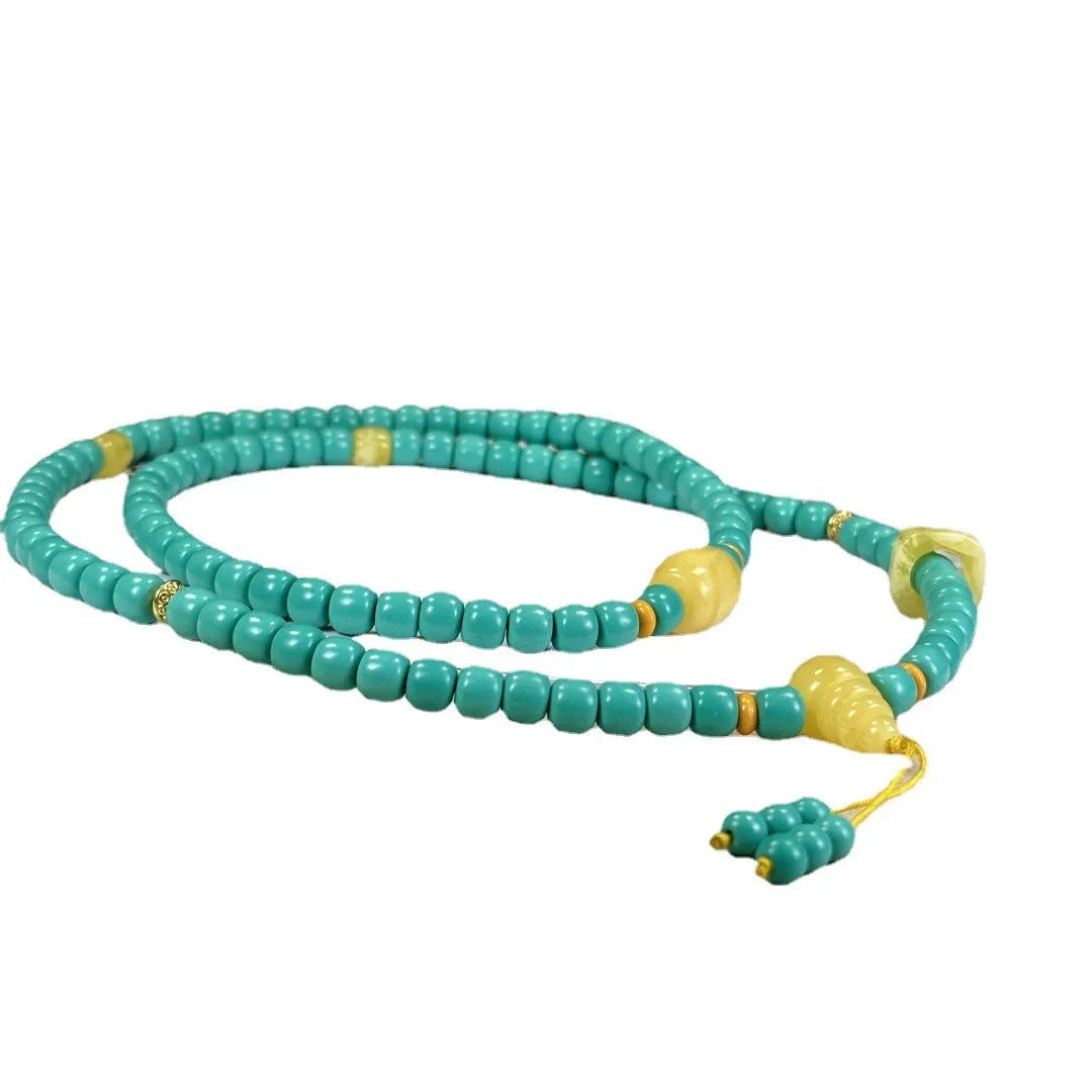 Turquoise mesh flower lucky pendant on a ball bead chain necklace, showing clasp.