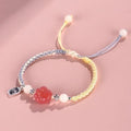 Red cat's paw charm couples bracelet with pink woven base, handmade glass and glaze jewellery