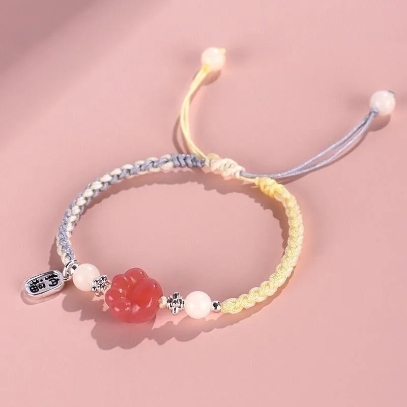 Red cat's paw charm couples bracelet with pink woven base, handmade glass and glaze jewellery