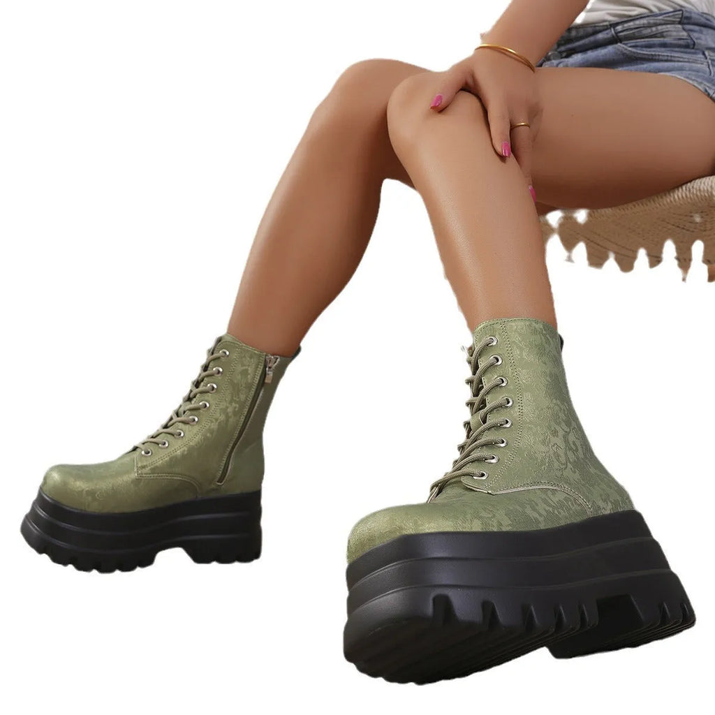 Women's black retro platform Martin boots with patchwork detail and side zipper.