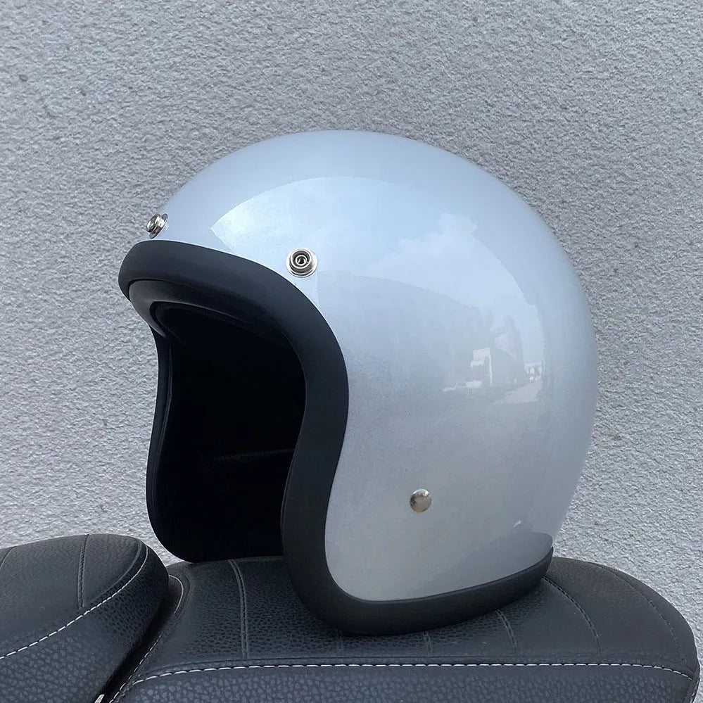 Retro-style open-face motorcycle half helmet in cement grey with a glossy FRP shell and quick-release chin strap.