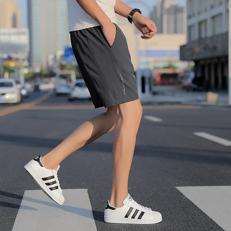 Men's grey cotton quick-drying five-point sports shorts with elastic waistband, front view