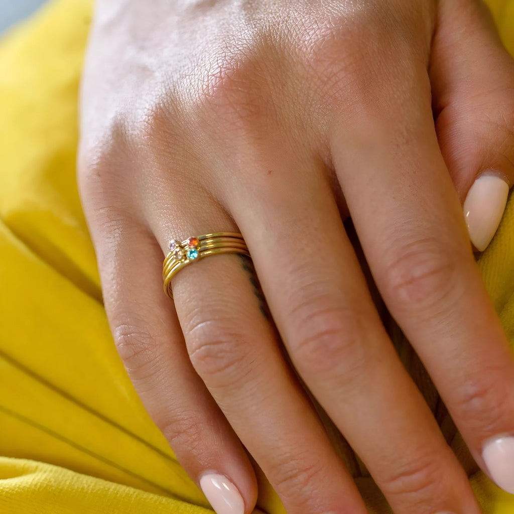 A geometric titanium steel ring with a December colour birthstone in an engraved, superimposed design.