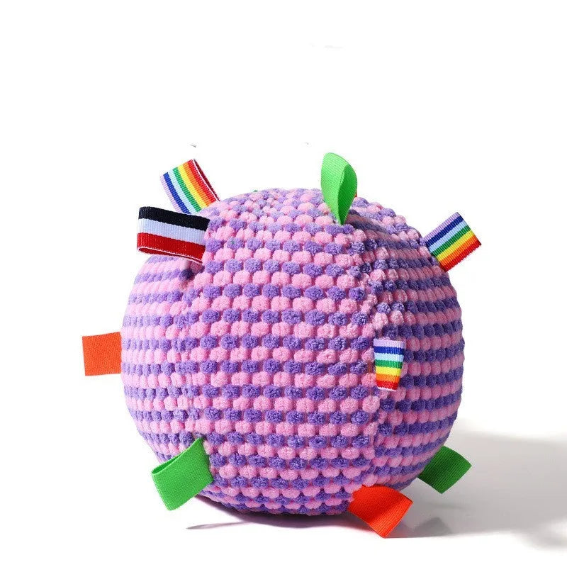 Blue and yellow textured rubber dog ball with holey lattice design, 17cm in diameter, on a wooden floor.
