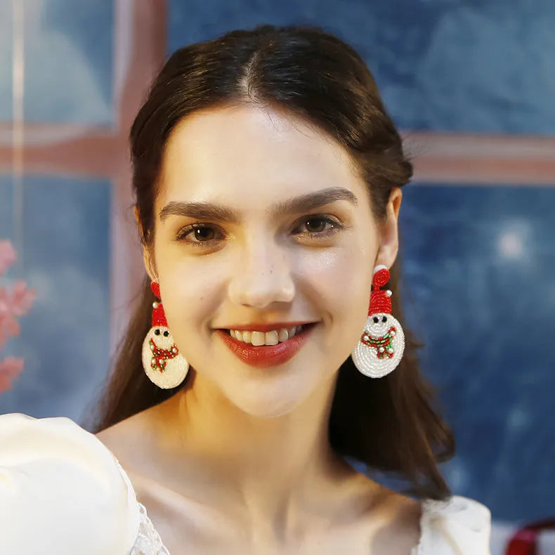 White acrylic snowman bead earrings on a white background, geometric shape, one pair shown