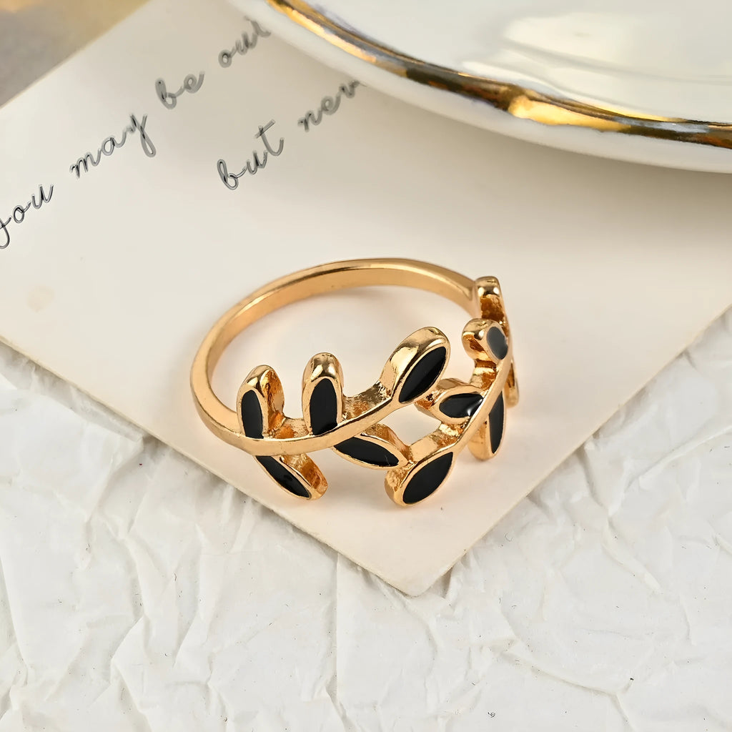 Geometric leaf ring with gold electroplated finish and simple floral design on finger
