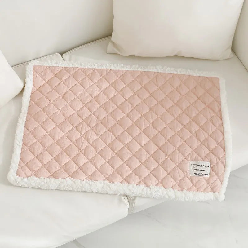 Blue quilted terry cloth cat blanket shown in a pet bed.