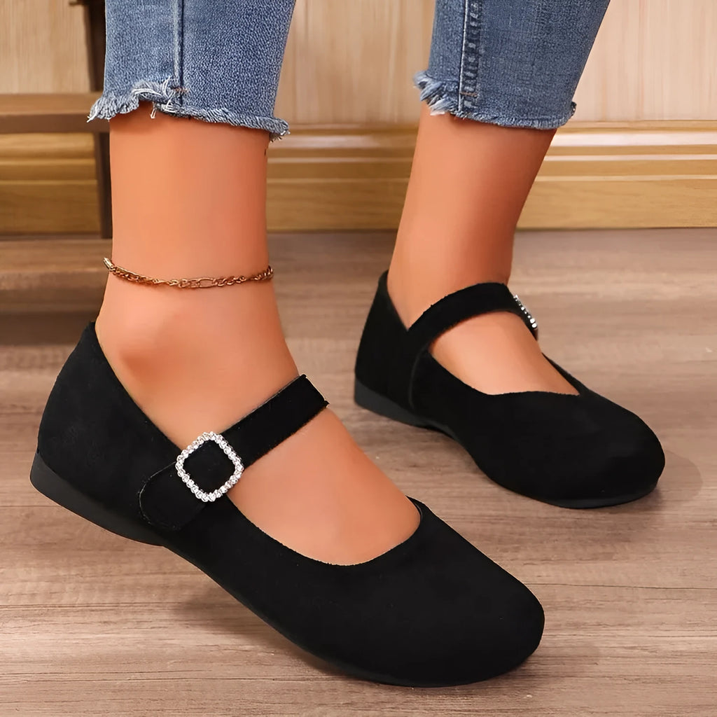 A pair of black men's canvas fisherman flat shoes with a rubber sole on a white background.