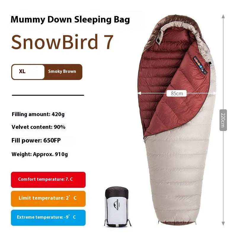 Blue and grey mummy-style down sleeping bag packed in its storage bag for camping.