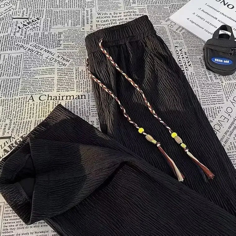 Korean style men's summer pants in black with drooping texture and folding craft detailing