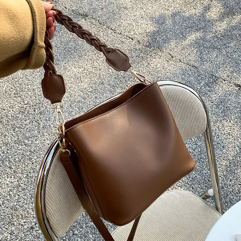 Khaki women's crossbody bucket bag with woven front texture and adjustable long strap