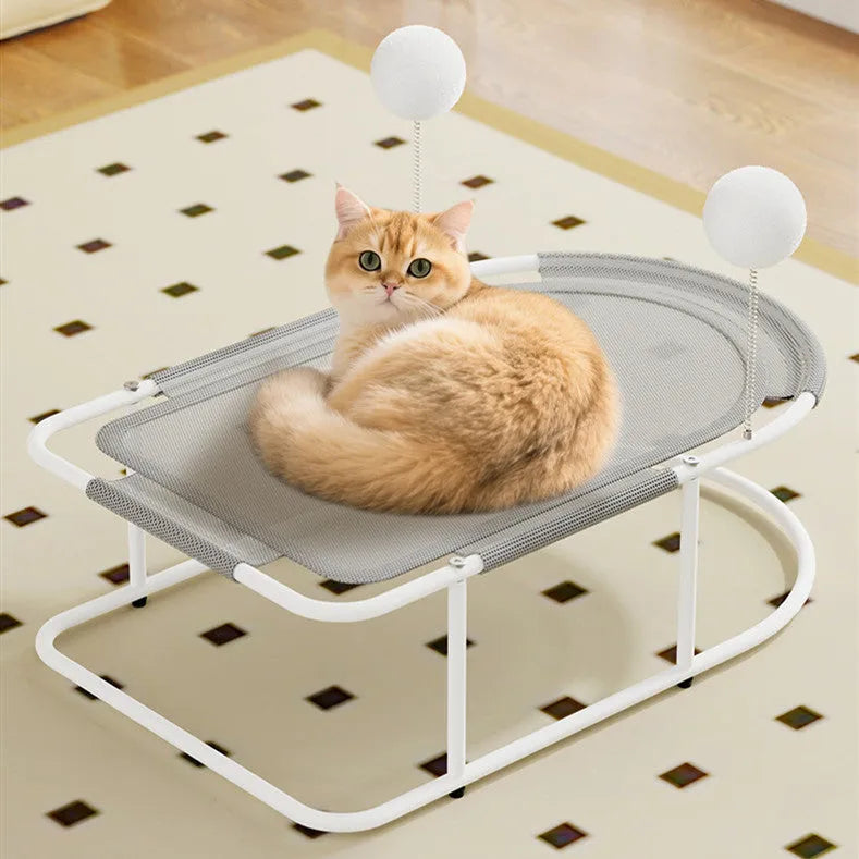 Grey metal frame cat kennel with a soft breathable fabric bed elevated off the floor.