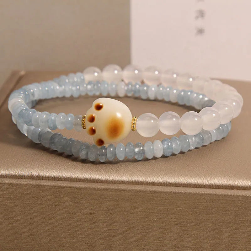 Women's crystal bracelet with aquamarine abacus beads, white agate, and cat's paw accents in double ring design